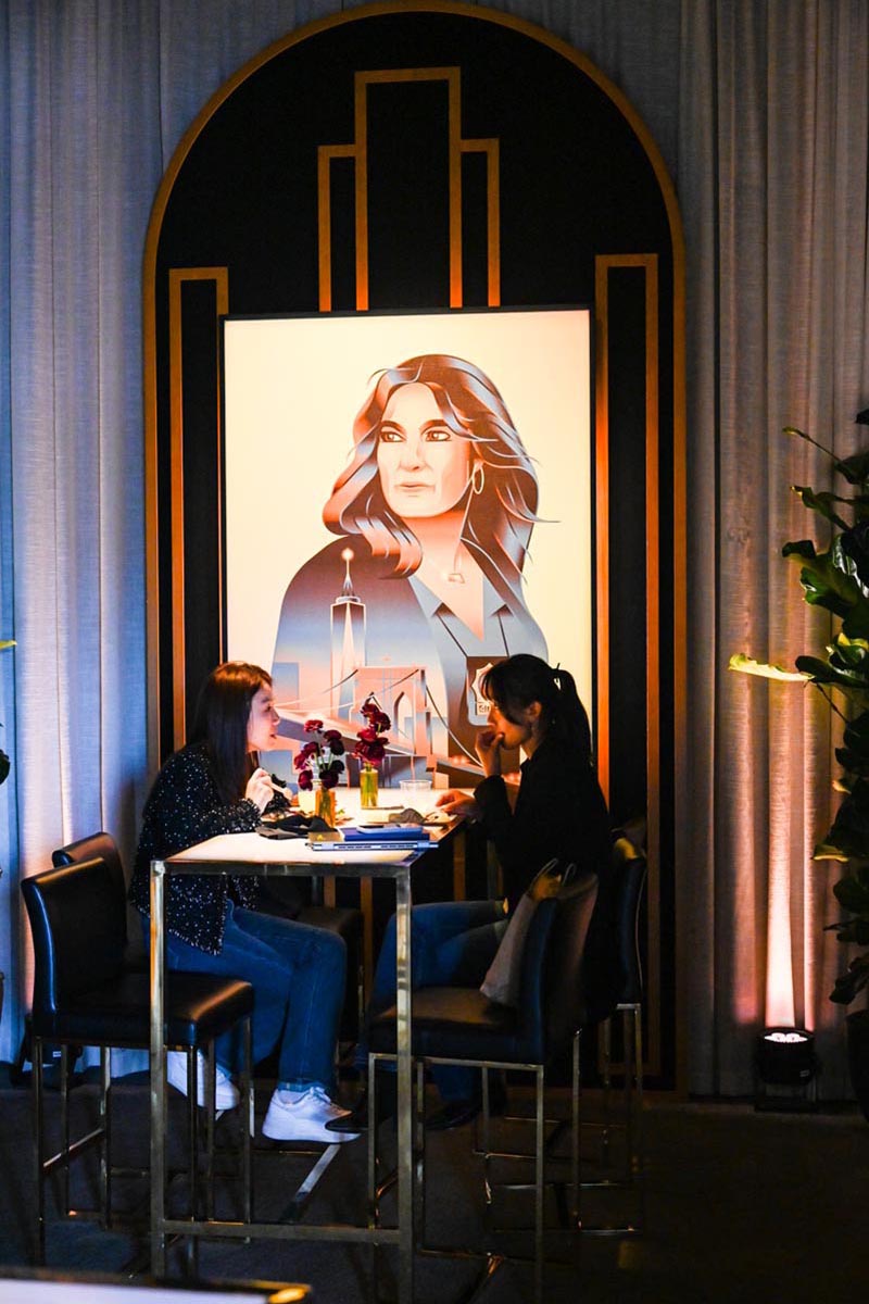 nbcu-la-screenings-2026-event-interior-07 Two women dining near a portrait.