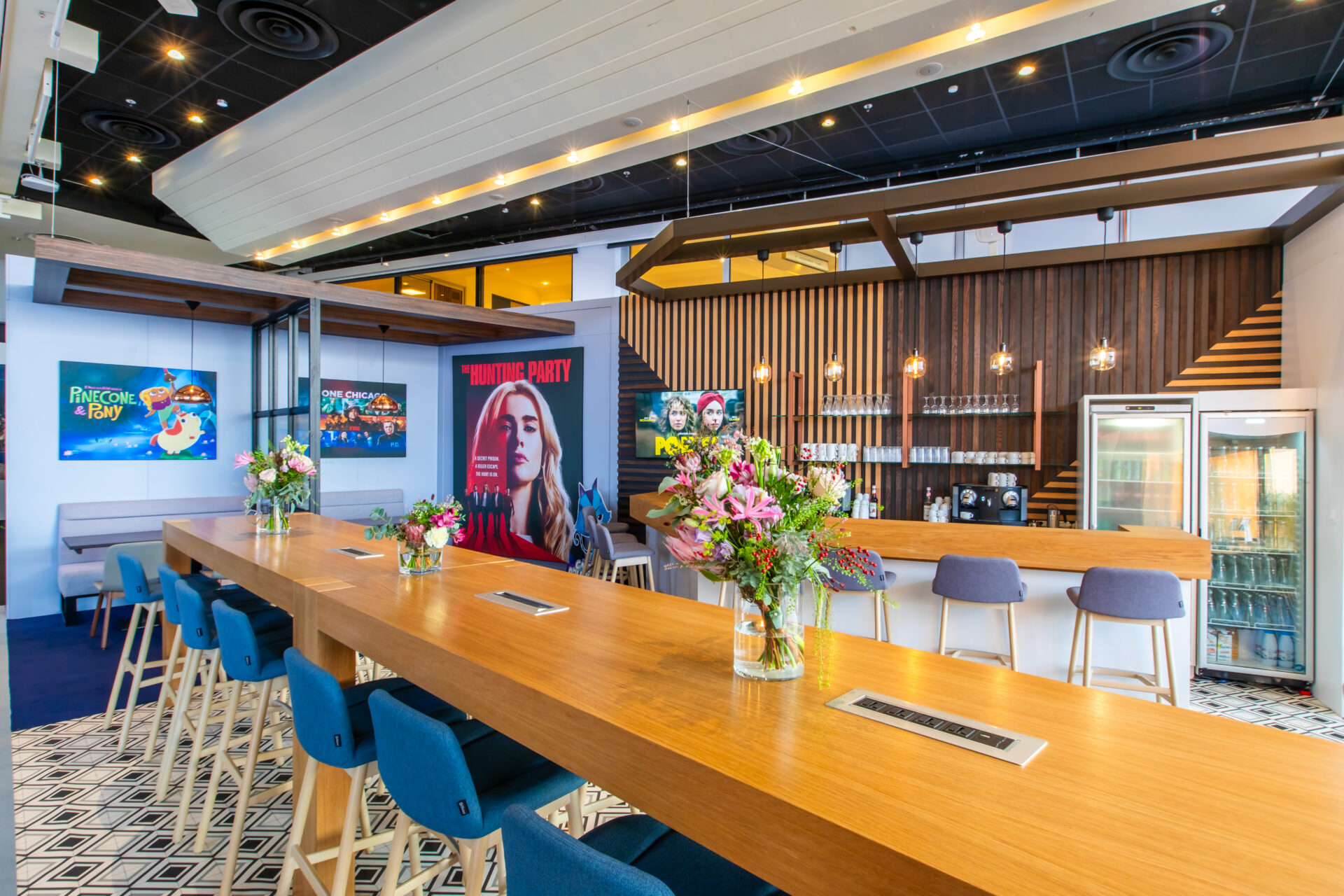 Modern bar with floral arrangements.