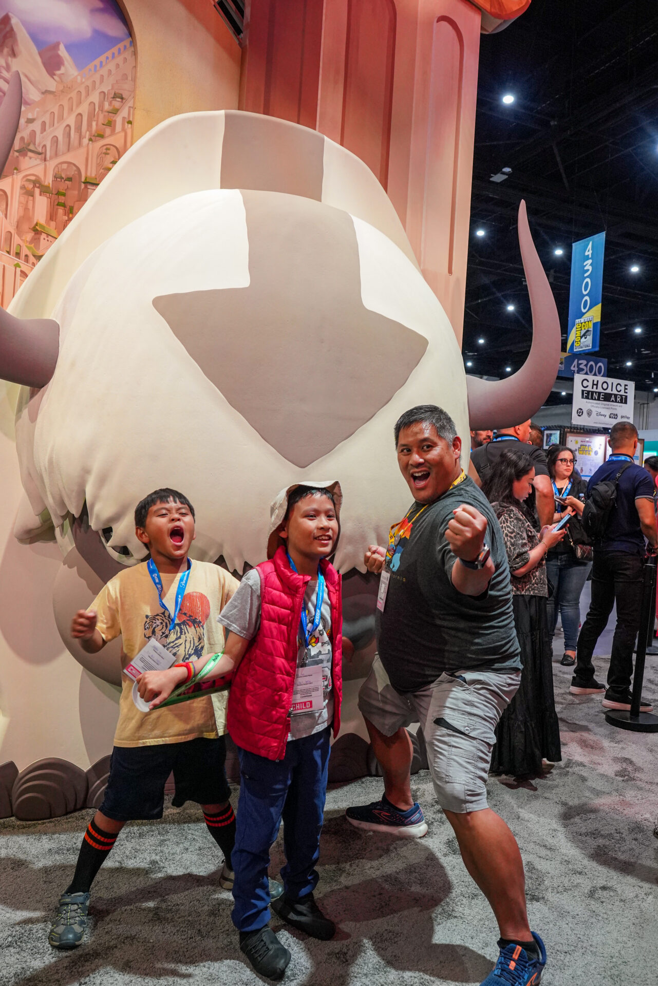 Kids and adult posing with sculpture